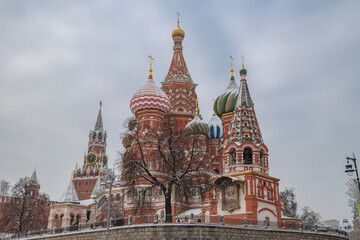 Fototapeta na wymiar Ancient Cathedral of the Intercession of the Holy Virgin on the Moat (.St. Basil's Cathedral) on a cloudy January day. Moscow, Russia