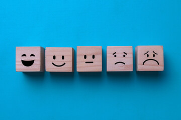 Customer service evaluation, feedback, and satisfaction survey on wooden blocks.