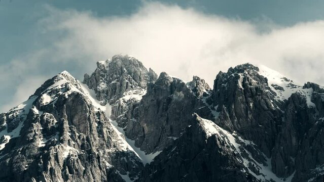 Timelapse of clouds over a dramatic snowy mountain range in Theth Albania