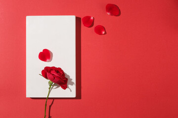 White podium in rectangle shaped arranged against red background with few rose petals. Product presentation, mockup, show cosmetic product, Podium, stage pedestal or platform © Tuan  Nguyen 