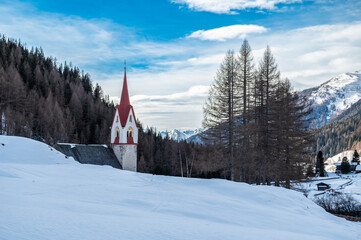 Church of Santo Spirito immersed in the snow of Val Aurina