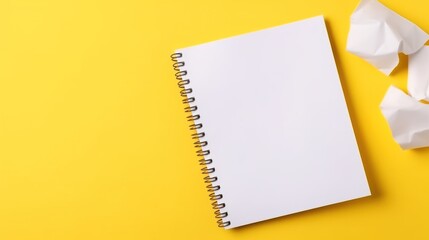 school stationery white sheet of notebook paper on a yellow background. Top view, 