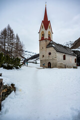 Fototapeta na wymiar Church of Santo Spirito immersed in the snow of Val Aurina