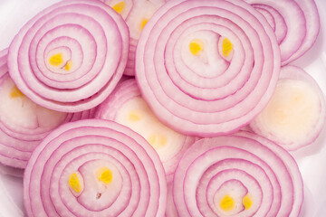 Sliced shallots or red onion on white background.