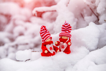 Obraz na płótnie Canvas Christmas toys stand on the branches of a snow-covered fir tree 