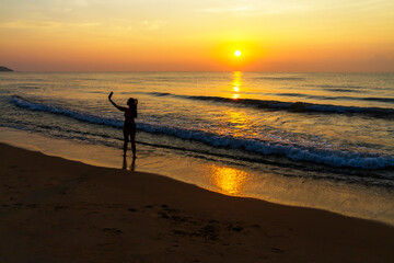 Woman body big with bikini and sunrise on beach