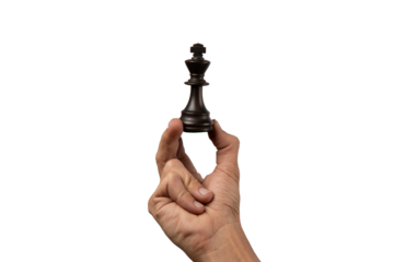 Male hand holding king chess figure isolated.