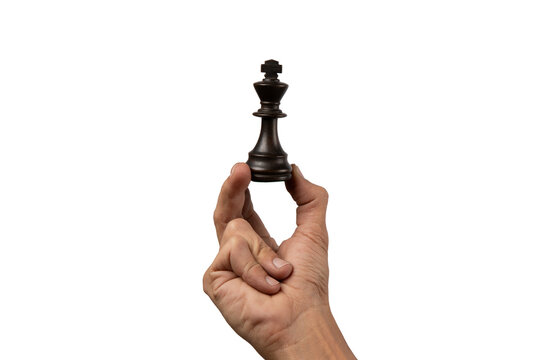 Male hand holding king chess figure isolated.