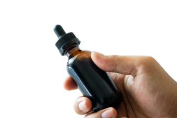 hand holding a black bottle isolated