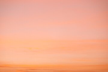 A beautiful sky tinted by the sun leaving vibrant shades of gold, pink, blue and multicolored. Clouds in the twilight evening and morning sky. Cloudy sky background in the evening and during the day.