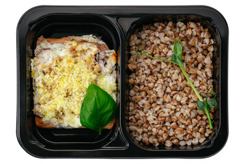 buckwheat with baked fish in lunch box on white background