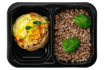 buckwheat with baked fish in lunch box on white background