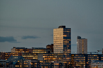 Modern city with illuminated skyscrapers in evening