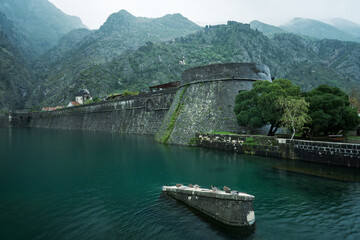 Fototapeta premium Kotor old city walls and surrounding mountains on a rainy day