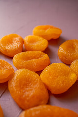 dried apricots in macro shot on pink background
