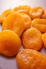 dried apricots in macro shot on pink background
