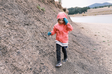 Girl walking along the shore of Dillon reservoir, Colorado