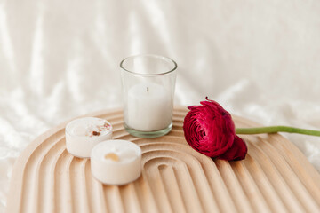 Nordic Style Wellness with Candles and a Ranunculus Stem