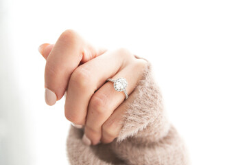 Diamond Ring on Woman's Closed Hand, wearing sweater