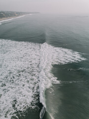 Wave crashing at T-Street shot from drone