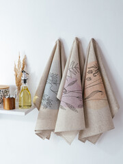 a towel made of natural linen is hanging on the wall in the kitchen