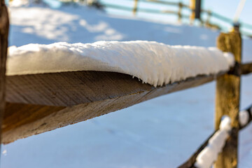 Perspective shot of snow on wood fence