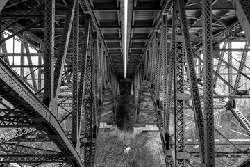 Geometric view of trestles under overpass in black and white