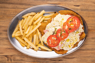 Overhead view of a plate of Neapolitan Milanese with French fries