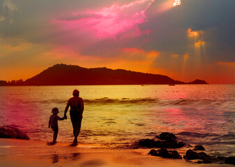 Child girl with mother on the beach.  rear view. Relaxing. Summer sunset. Enjoying Life.