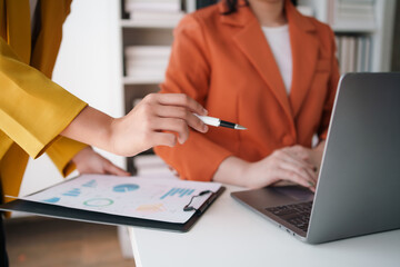 Business representatives meeting pointing on laptop computer. Business team discussing investment plan using data on laptop.
