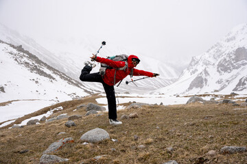 Male mountain climber on top of snowy peak.