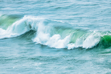 Wave splashing close-up. Crystal clear sea water, in the ocean in San Francisco Bay, blue water, pastel colors.