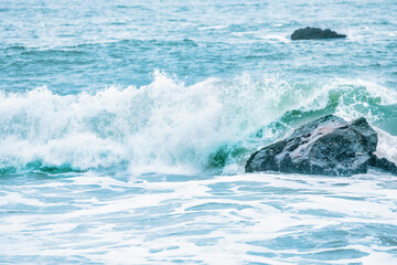 Wave splashing close-up. Crystal clear sea water, in the ocean in San Francisco Bay, blue water, pastel colors.