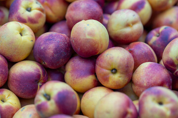 Fresh ripe nectarines in the market, close-up.
