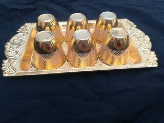 Small golden glasses in water