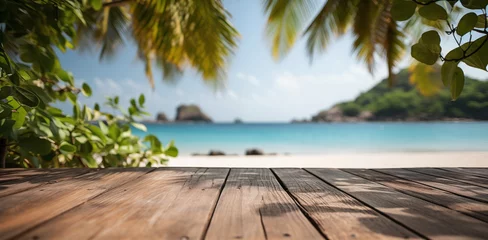 Fotobehang Empty wooden table with tropical beach theme in background © Katrin_Primak