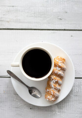 tubes with cream and coffee. on a wooden background. dessert