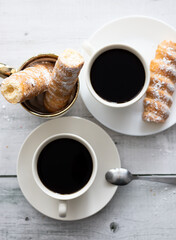 tubes with cream and coffee. on a wooden background. dessert