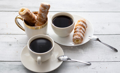 tubes with cream and coffee. on a wooden background. dessert