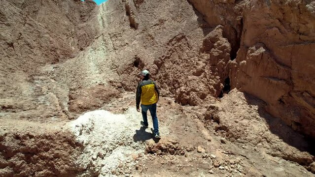 Beautiful aerial footage of the a person walking alone in the Atacama Dessert - Calama - Antofagasta Dessert and Salar - turquoise lagoon.