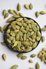 Healthy green cardamom kept on a white background.