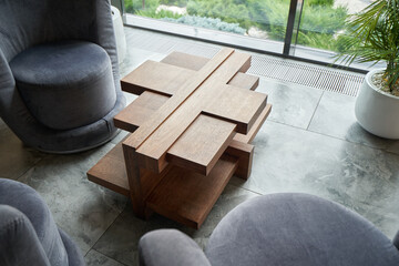 Unique wooden table in a modern style in the living room.
