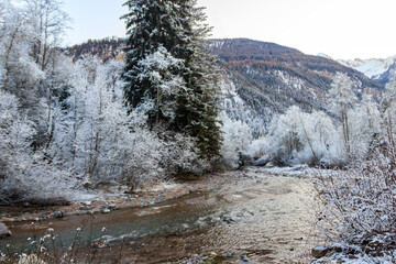View of winter river in the Swiss Alps, Switzerland. Snowy mountain river landscape
