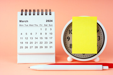 March 2024 Desk Calendar with alarm clock and adhesive note