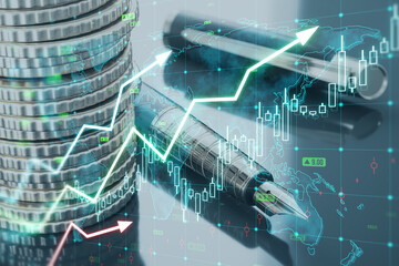 Close up of of stacked coins and pens, growing forex chart arrow and icon on blurry desk...