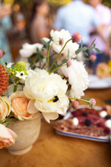 Wedding table for guests, decorated with candles, are served with cutlery and crockery and covered with yellow tablecloth