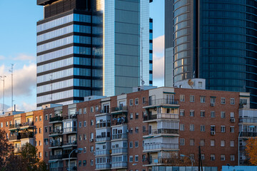 Urban landscape of apartment buildings and in the background modern offices towers in Madrid, Spain