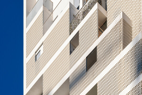 Detail of the white facade of a modern apartment building in the city of Madrid in Spain