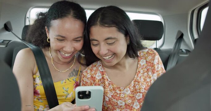 Woman, friends and phone on road trip with laugh, meme or smile with funny video, adventure or car. Girl, together and reading with blog, journey or holiday with comic video on web in transportation