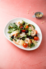 Shrimp salad with pine nuts and cheese